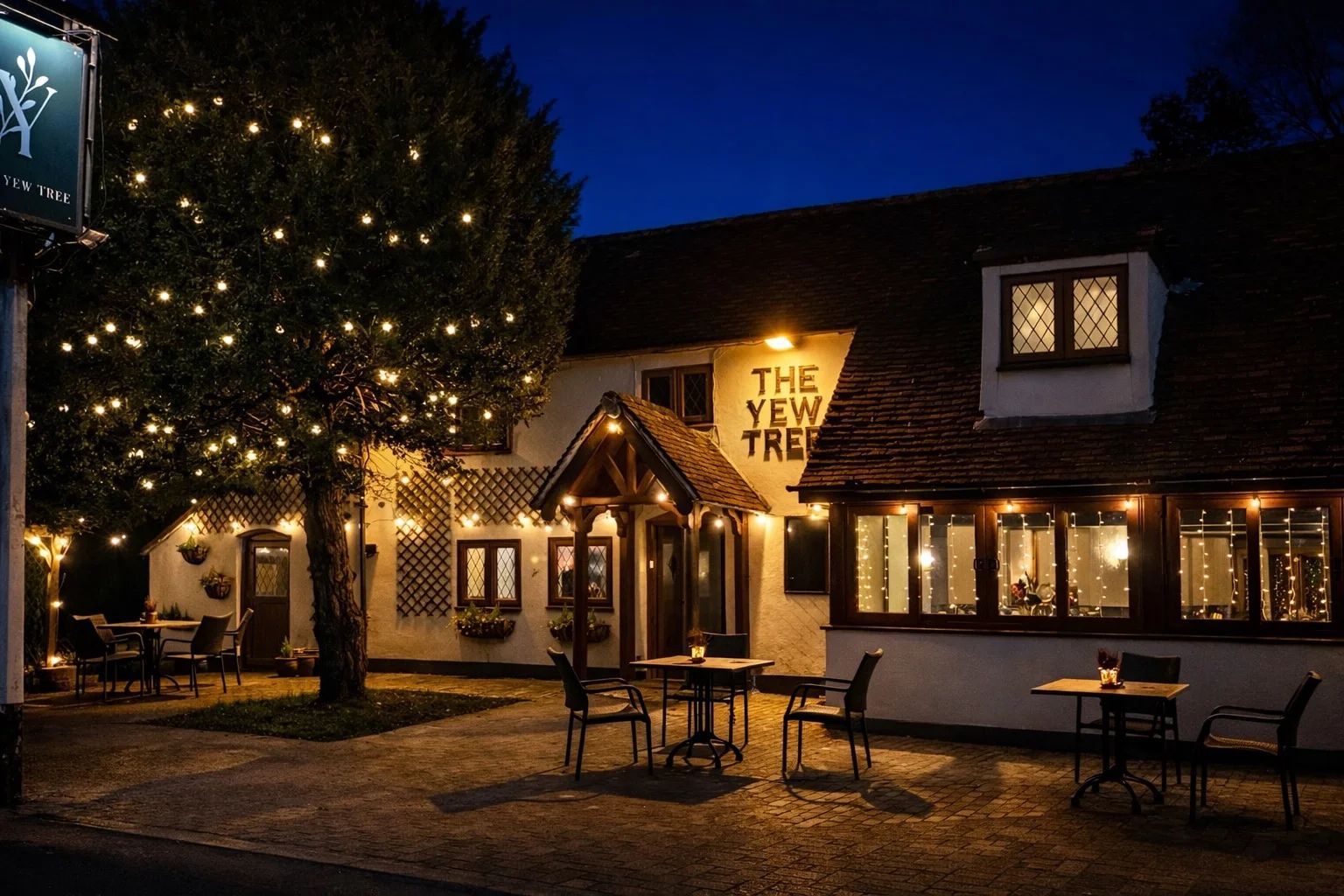 The Yew Tree, a countryside pub in Sandling, Maidstone, lit up at dusk